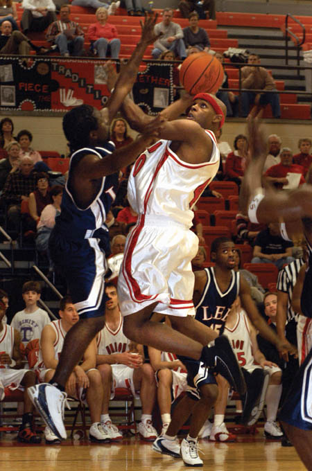 Senior guard Zach Wiggs scores on a steal against Lee University in Union’s 78-68 win during Homecoming 2004. - Photo by Jim Veneman