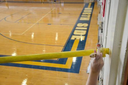 Kaetlyn Schmelzer, sophomore nursing major, paints the railings at North Side High School during Campus and Community Day. - Photo by Ebbie Davis