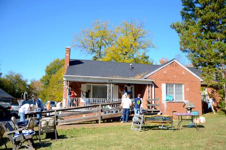 Students volunteer at a local home by painting, fixing gutters, scraping and re-painting for Union's ninth annual Campus and Community Day. - Photo by Ebbie Davis