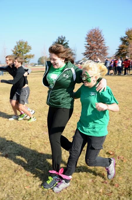 Morgan Jones, freshman nursing major, competes in a three-legged race with Ruthie Hall, freshman English major, during Homecoming Olympics. - Photo by Jacob Moore