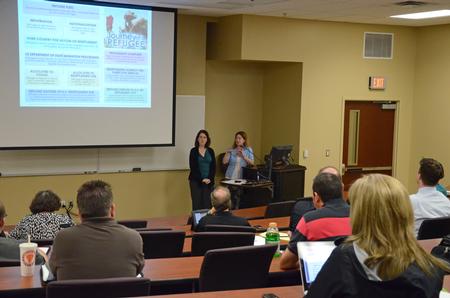 Jennifer Escue and Louisa Saratora, who serve with Catholic Charities of Tennessee, speak at the "Culture and Crisis" Town and Gown lecture series.  - Photo by Anne Richoux