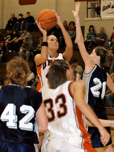 Senior forward Ginger Bryant (42) attempts a shot over a Berry College defender.  Union's Stephanie Clark (33) prepares for a rebound. - Photo by Kristen Hiller