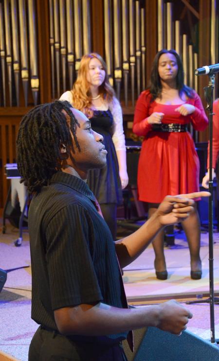 Derique Cannon, junior electrical engineering major, leads MOSAIC choir as they perform in chapel. - Photo by Zac Calvert
