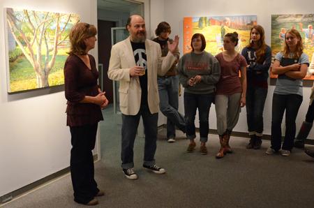 Lee Benson, professor of art and department chair, introduces Lisa D. Line, an artist featured in the art gallery.  - Photo by Anne Richoux