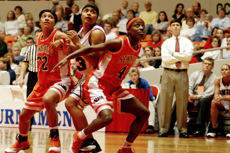 Christina Smith (23) gets sandwiched between two Auburn-Montgomery players in a rebound attempt during the NAIA National Tournament. - Photo by Kristen Nicole Sayres