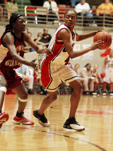 Latorya Fuller (4) handles the ball against a Southern Nazarene defender during the Elite Eight round of the national tournament. - Photo by Kristen Nicole Sayres