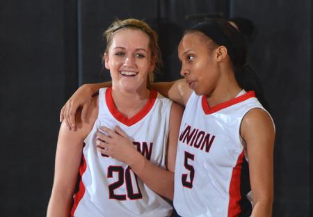 Amy Philamlee and LeTesa McLaughlin share a fun moment in the waning moments of their game with Saint Xavier University. - Photo by Morris Abernathy