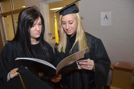 Fellow Psychology majors Catherine Hamilton and Brittany Dement look to make sure they are in the correct order in line  just before the Commencement Service.  - Photo by Morris Abernathy