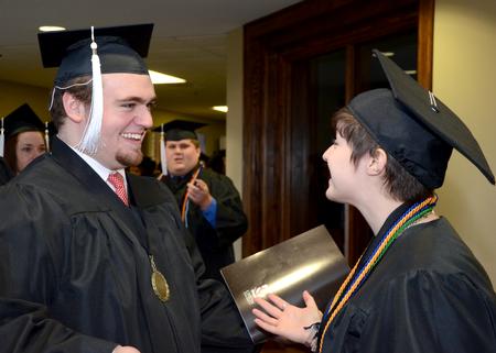 Rob Simpson, digital media studies graduate, and Kristen Marks, art graduate, talk in line prior to going into Union's Fall Commencement Services held at West Jackson Baptist Church. - Photo by Ebbie Davis