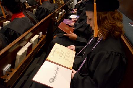 Danielle Blackstone, nursing graduate, looks over her diploma after graduating during the 2011 Fall Commencement Services. - Photo by Ebbie Davis