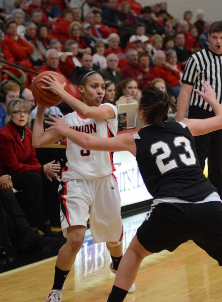 Photo by Jacob Moore
Lady Bulldog LaTesa McLaughlin looks for a pass against Freed Hardeman's Grace Alonso de Armino during a game Feb. 11 at the Fred DeLay Gymnasium. - Photo by Jacob Moore