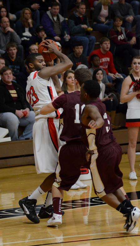 Photo by Jacob Moore
Bulldog Antoine Hall looks for a pass while guarded by Freed Hardeman's Jonathan Milewski and Anthony Sampson during a game Feb. 11 at the Fred DeLay Gymnasium. - Photo by Jacob Moore