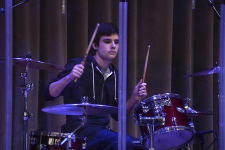 Joey Davis, sophomore business marketing major, plays drums during the music portion of chapel. - Photo by Jacob Moore