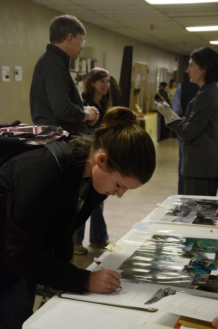 Sam Howard, junior chemistry major, signs up for more information at the external study fair in the Penick Academic Complex.  - Photo by Anne Richoux