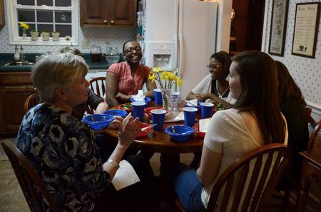 Pam Sutton, professor of English, talks with Jamie Mitchell, junior English major, in Sutton's home. During SAC's Be Our Guest, faculty and staff open their homes to students for a home-cooked meal.  - Photo by Anne Richoux