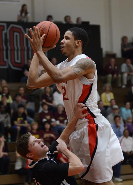 Leventrice Gray shoots over Freed Hardeman University's Jonathan Milewski during the opening round of the TranSouth Athletic Conference Championship. - Photo by Jacob Moore