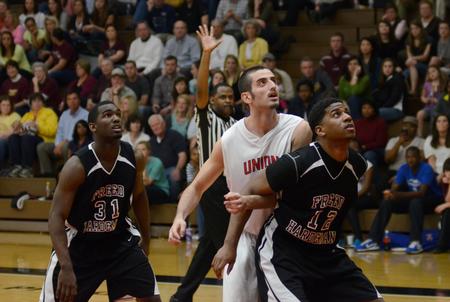 Dani Marti looks for a rebound against Freed Hardeman University's Orlando Bass and Reginald Gilmore during the opening round of the TranSouth Athletic Conference Championship. - Photo by Jacob Moore