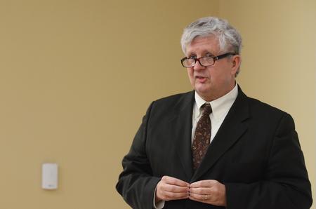 Tom Cooper, author of <em>Fast Media/Media Fast</em> and professor of visual and media arts at Emerson College, speaks during the Town & Gown lecture series about media, politics & democracy. - Photo by Zac Calvert