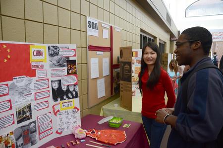Margaret Wu, MBA student, talks about the culture in China with Joshua Jenkins, freshman engineering major, during CultureFEST. - Photo by Zac Calvert