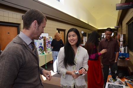 Phillip Ryan, associate professor of language and coordinator of the ESL program, chats with Kendra Loh, sophomore psychology major, about her home in Malaysia during CultureFEST. - Photo by Zac Calvert