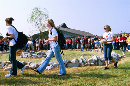 One by one, students removed the stones from the altar of the September 11 Memorial Environmental Installation. - Photo by Jim Veneman