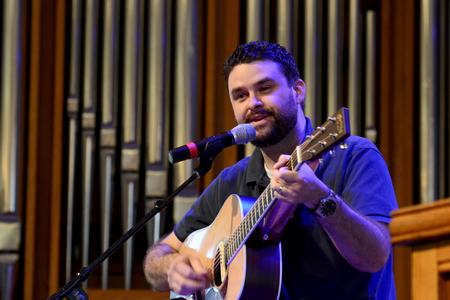 Ben Williams, member of Christ Community Church, leads music during chapel. - Photo by Jacob Moore