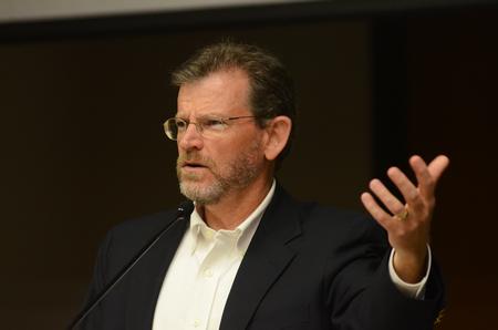 James Scruton, poet and head of the humanities division at Bethel College, reads some of his poetry in Harvey Auditorium. - Photo by Zac Calvert