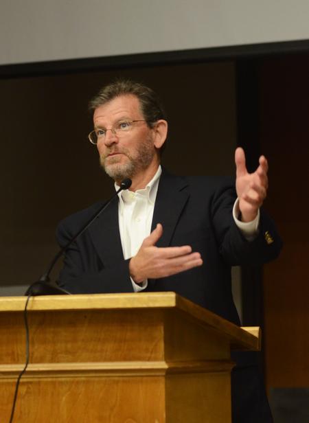 James Scruton, poet and head of the humanities division at Bethel College, reads poetry that he has written about his family, experiences and simple observations. - Photo by Zac Calvert