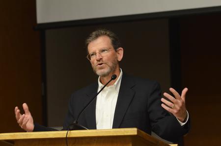 James Scruton, poet and head of the humanities division at Bethel College, reads poems from books he has written over the years. - Photo by Zac Calvert