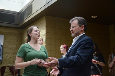 Heather Franks, junior English major, talks to James Scruton, poet and head of the humanities division at Bethel College, after his poetry reading in Harvey Hall. - Photo by Zac Calvert