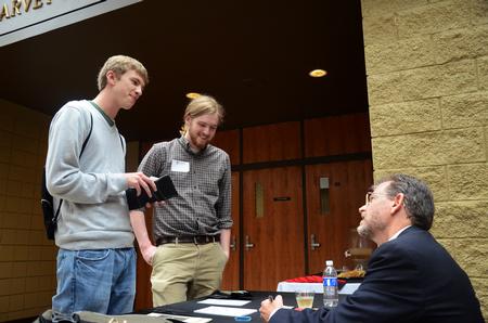 Michael Lewis, senior biology major, and Austin Gray, junior English major, talk to James Scruton, poet and head of the humanities division at Bethel College, after Scruton's poetry reading. - Photo by Zac Calvert