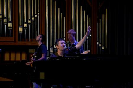 Jordan Pratt (left), senior psychology major, and Ben Wilson (right), senior chemistry major, lead worship along with Travis Cottrell, worship pastor at Englewood Baptist Church. - Photo by Anne Richoux