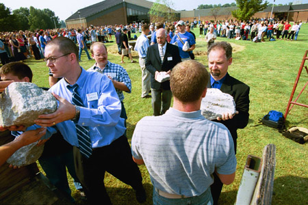 Union employees Ronnie Smith, Charlie Agnew, Richard Joiner and Michael Mallard participate in the removing of the stones from the altar of the September 11 Memorial Environmental Installation. - Photo by Jim Veneman