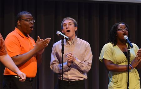 David Madden, freshman digital media studies major, Zac McMillan, sophomore intercultural studies major, and Treasure Hightower, senior digital media studies major, sing in chapel with MOSAIC choir. - Photo by Jacob Moore