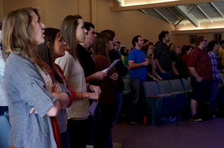Students sing hymns prior to G.O. trip reports in chapel.  - Photo by Anne Richoux