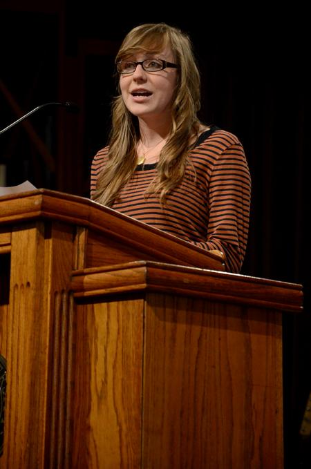 Cari Phillips, senior public relations major, speaks in chapel about her G.O. trip to Memphis.  - Photo by Anne Richoux