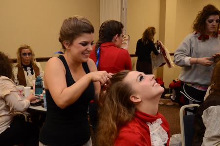 Rachel West, freshman nursing major, helps style hair for Taylor Klock, freshman English major, for Zeta Tau Alpha's performance at the 15th annual Variety Show. - Photo by Jacob Moore