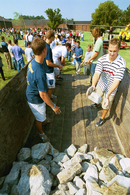 A number of students participated in an assembly line formed to finish the removal of the stone altar during the September 11 Service of Remembrance and Response.  (right - Sophomore Chadd Hodges, Christian studies major) - Photo by Justin Veneman