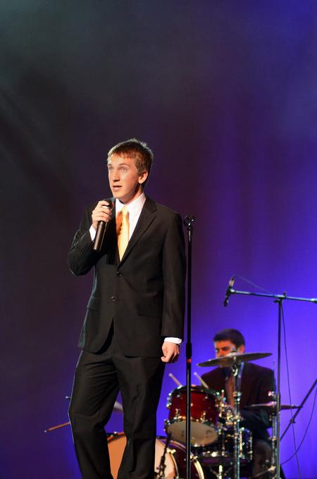 Zac McMillan, sophomore intercultural studies major, sings at the 15th Annual Variety Show, which was hosted by SAC, while the judges finalize their votes. - Photo by Zac Calvert