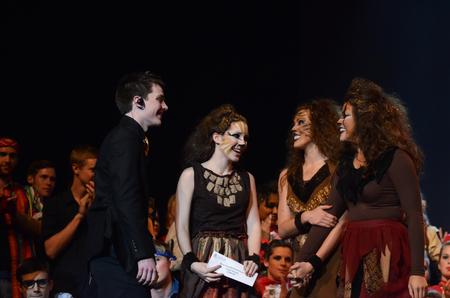 Matthew Parker, senior business administration major, presents the women of Chi Omega with the best overall large group award for the 15th Annual Variety Show. - Photo by Zac Calvert