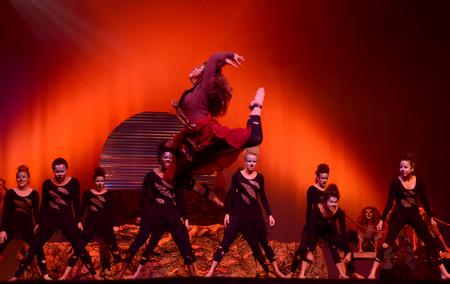 Libby Parks, senior nursing major, performs a stag leap during Chi Omega's Lion King themed act at the 15th annual Variety Show. - Photo by Ebbie Davis