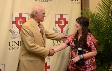 Terry Bradshaw, former NFL quarterback and current FOX Sports analyst, greets Ebbie Davis, senior broadcast journalism major, after the fourth annual Roy L. White Legacy Golf & Gala. - Photo by Jacob Moore