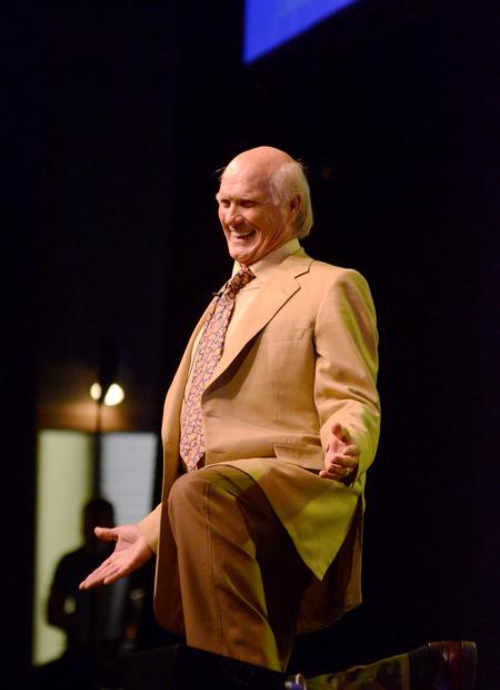 Terry Bradshaw, former NFL quarterback and current FOX Sports analyst, gets down on his knee while telling a story from his past to the audience of the Roy L. White Legacy Golf & Gala. - Photo by Zac Calvert