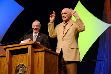 David S. Dockery, president of the university, presents keynote speaker Terry Bradshaw, former NFL quarterback and current FOX Sports analyst, with a Holman Christian Standard Bible with his name engraved on the front. Bradshaw shows excitement on receiving the gift.  - Photo by Ebbie Davis