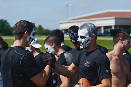 Jordan Norton, junior broadcast journalism major, congratulates Craig Davis, junior sports medicine major, after he won the football toss for Sigma Alpha Epsilon during Greek Olympics. - Photo by Zac Calvert