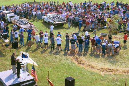 After all students passed through the line, several students made an assembly line to finish the removing of the stone altar during the September 11 Service of Remembrance and Response. - Photo by Amanda Smith