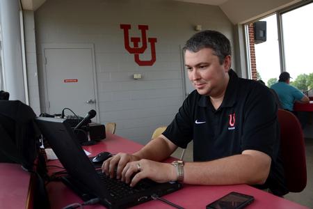 Steven Aldridge, director of sports information, works at the Fesmire Field House during a Bulldog baseball game. - Photo by Jacob Moore