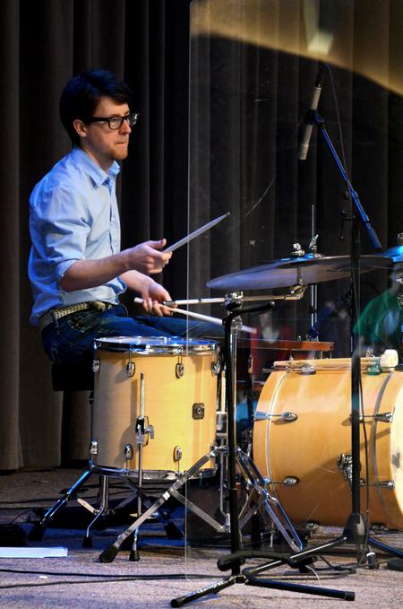 Aaron Beasley, graduate assistant in the office of spiritual life, plays the drums at the beginning of chapel. - Photo by Anne Richoux