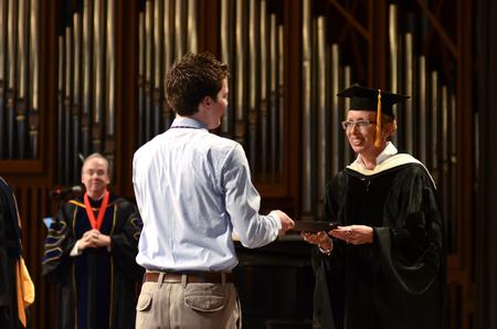 Barbara McMillin, associate provost and dean of instruction, awards Matthew Parker, senior business administration major, the Who's Who award for business administration during the annual Awards Day chapel service. - Photo by Jacob Moore