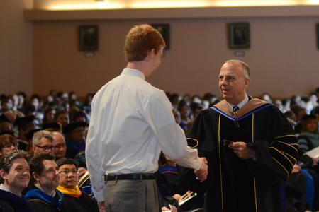 Bill Nance, associate dean of the McAfee School of Business Administration, presents the Academic Excellence Medal to Thomas Willis, broadcast journalism and business administration double major, during the annual awards chapel service. - Photo by Jacob Moore